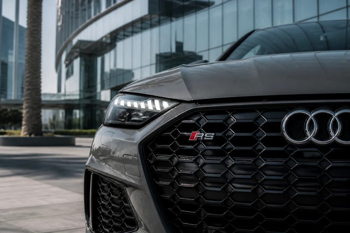 Audi RS honeycomb grille detail against Dubai glass architecture for Audi rental Dubai guide identity