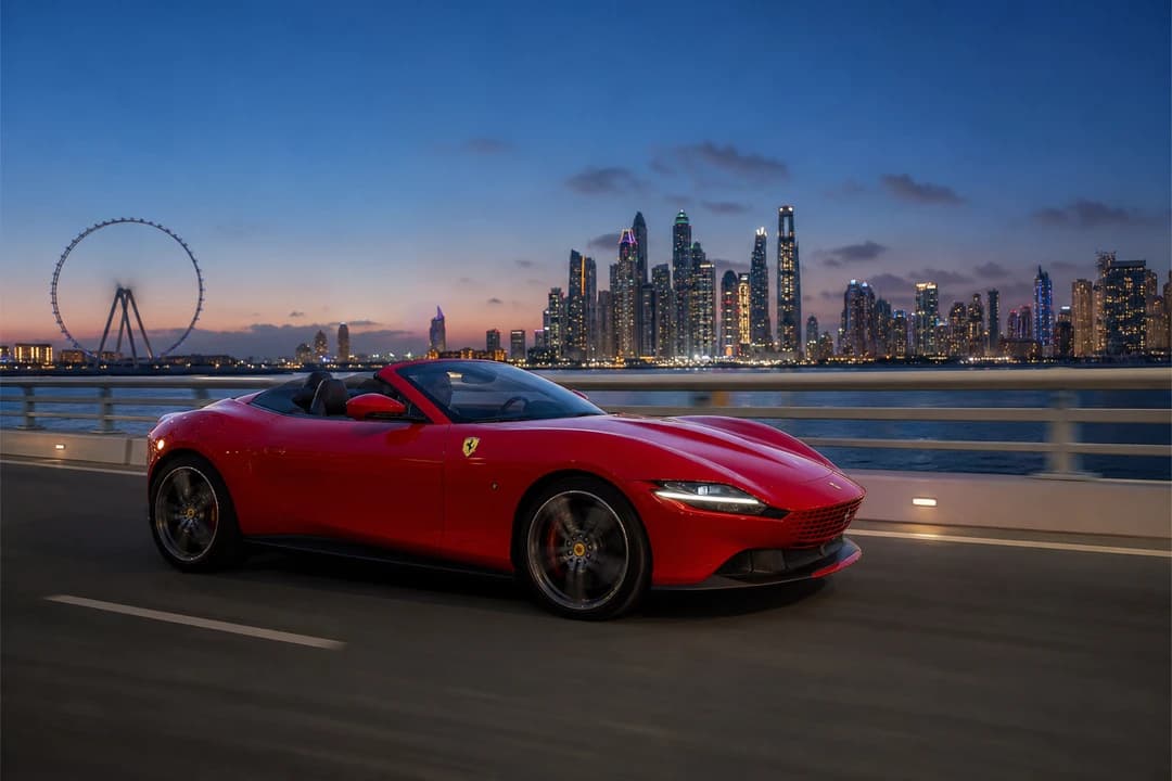 Ferrari Roma Spider on the Bluewaters Island access bridge at blue hour for convertible rental Bluewaters evenings