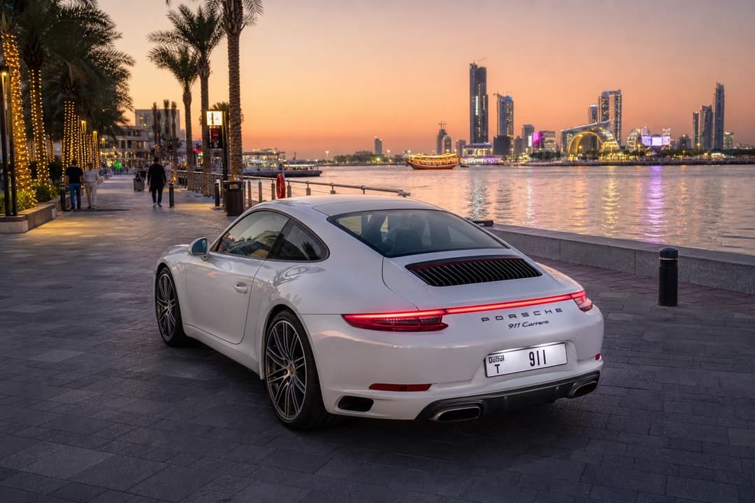 Porsche 911 on a Dubai Festival City creek-side promenade at sunset for UAE road trip rental evenings