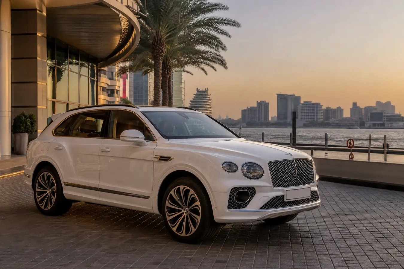 Luxury car rental Dubai Festival City hero with a white Bentley Bentayga at the mall waterfront at golden hour