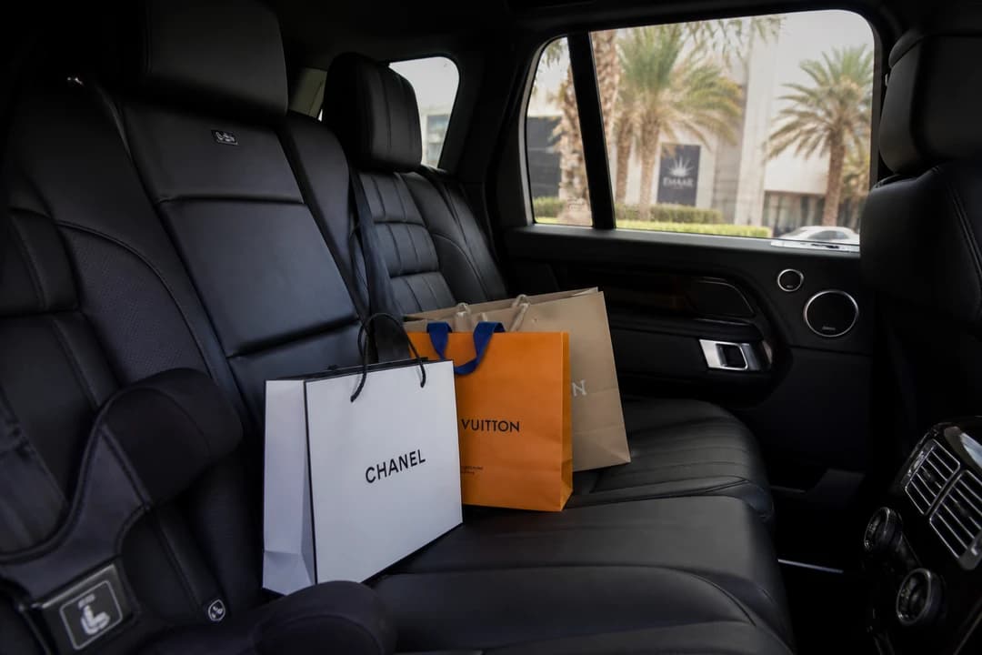 Range Rover rear cabin with soft shopping bags for best cars to rent Dubai Festival City family mall days