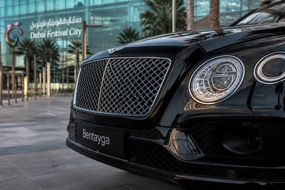 Bentley Bentayga grille against Dubai Festival City mall glass for luxury car rental Dubai Festival City