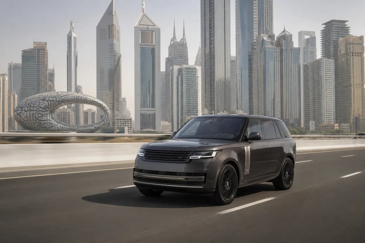 Luxury SUV on Sheikh Zayed Road in bright afternoon haze for luxury car rental Dubai summer comfort