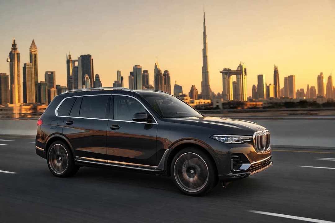 Rent BMW X7 Dubai exterior on Sheikh Zayed Road at golden hour for luxury car rental Dubai family hops