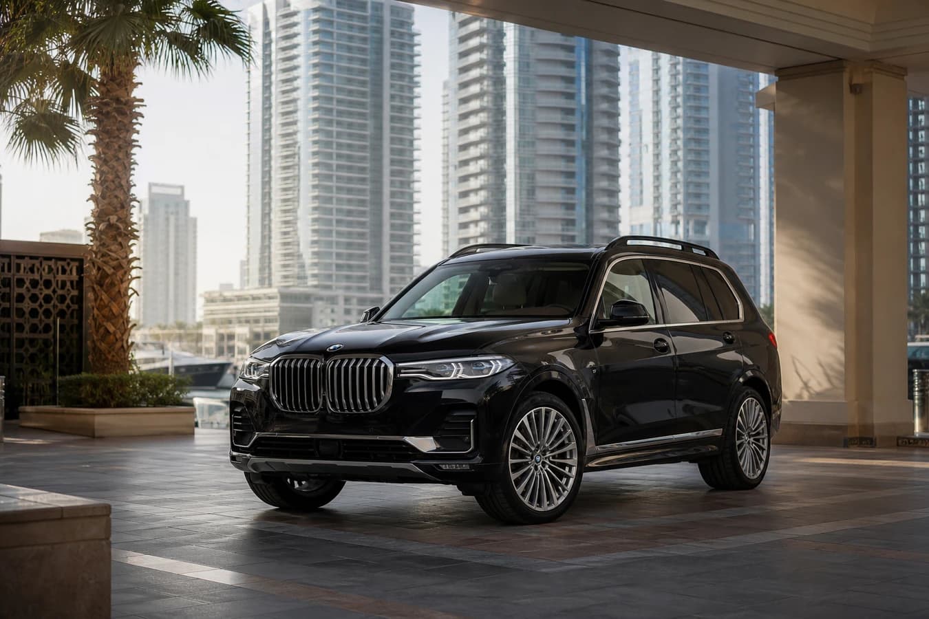 BMW X7 rental Dubai hero with three-row luxury SUV at a Marina hotel porte-cochère in morning light