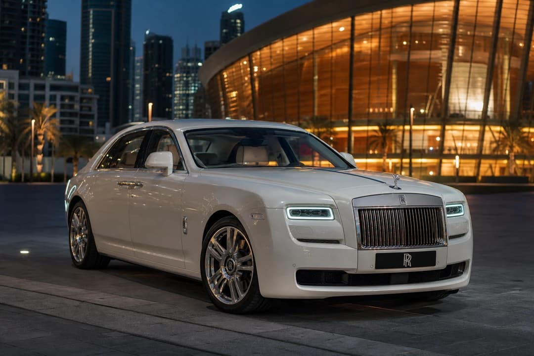 Rolls-Royce Ghost Series II at Dubai Opera plaza at dusk for luxury car rental Dubai proposal stills
