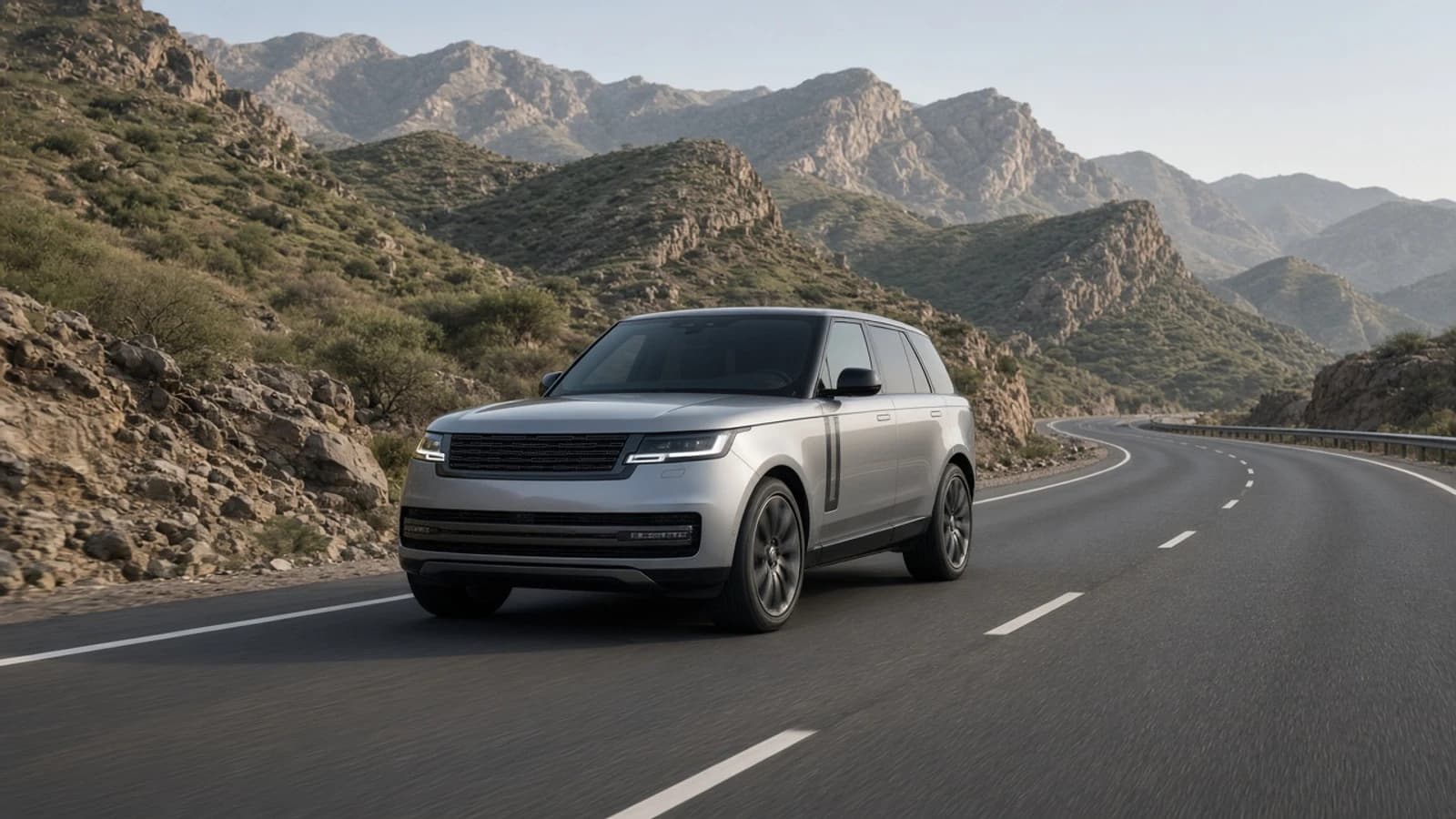 Dubai spring luxury SUV road trip: Range Rover on a Hatta mountain dual carriageway in soft spring morning light