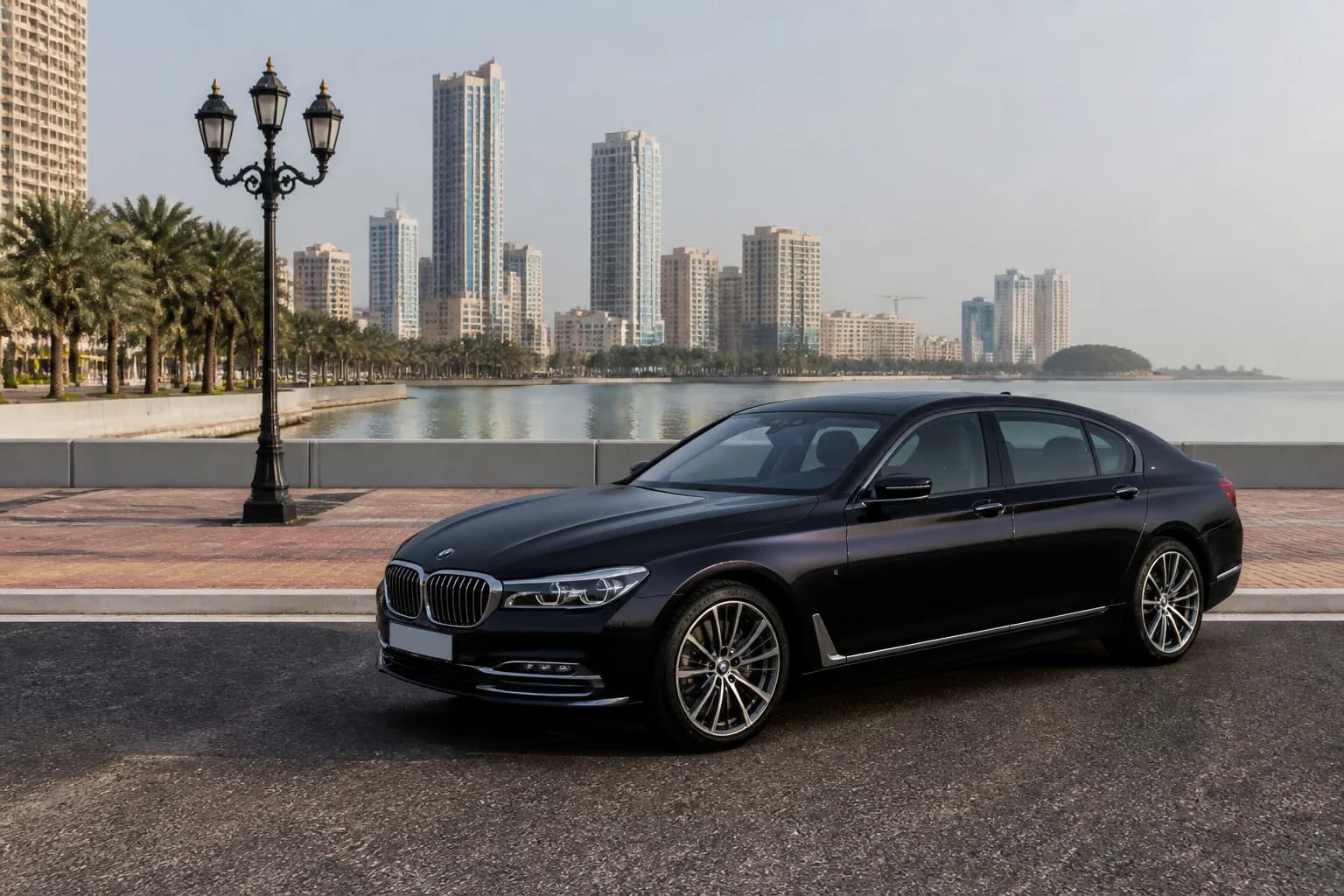 Best cars to rent Dubai for Ajman: luxury sedan near a calm Ajman corniche waterfront promenade