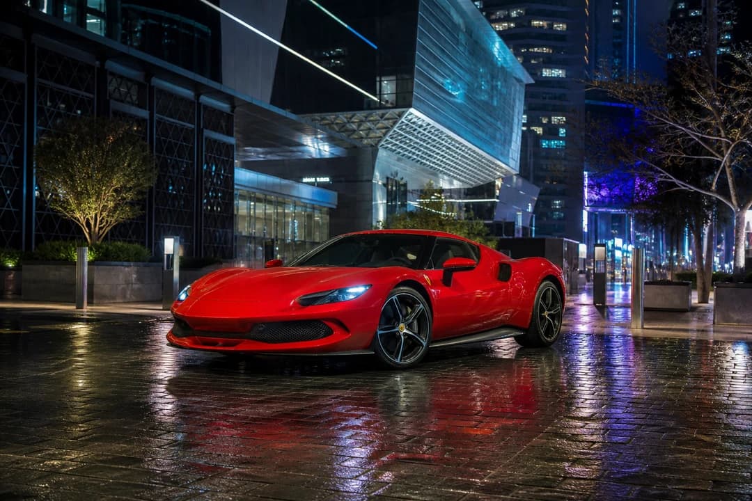 Ferrari 296 GTS with roof up at DIFC Gate Avenue at night for Ferrari car rental Dubai city arrivals