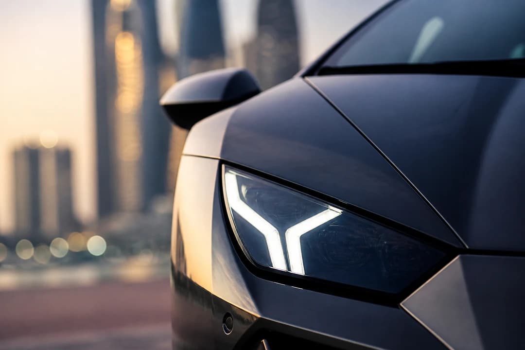 Lamborghini Y-shaped headlight detail contrasting coupe and SUV stance in Huracan vs Urus rental Dubai