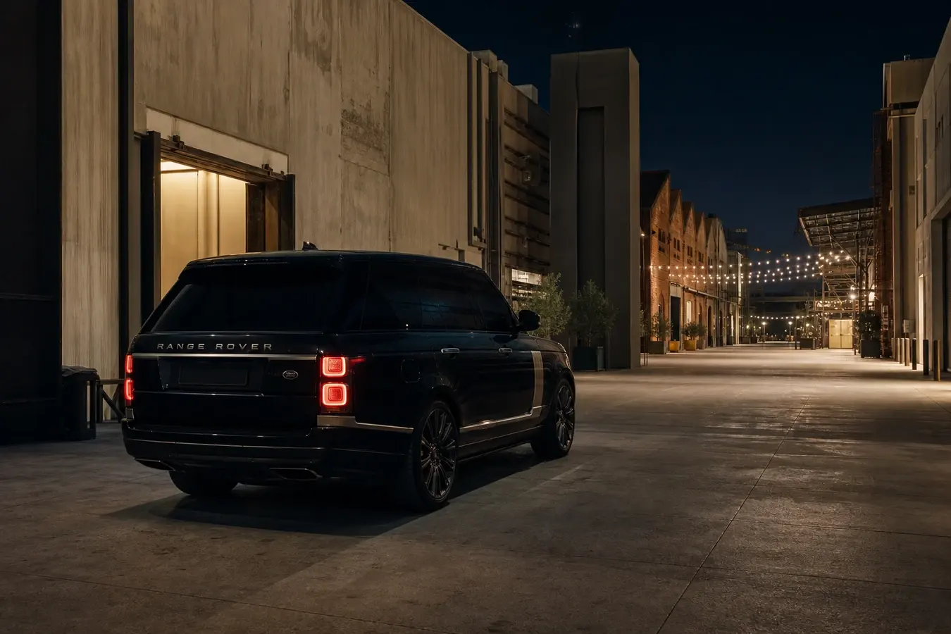 Luxury car rental Al Quoz Dubai hero with a Range Rover at an Alserkal warehouse courtyard in warm evening light