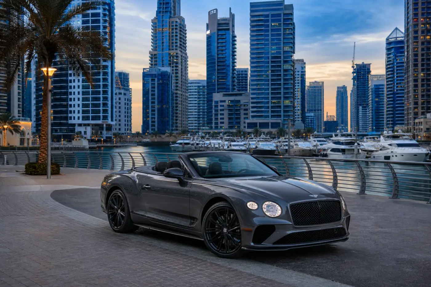 Luxury car rental Dubai winter hero with a Bentley Continental GTC at Dubai Marina Walk in cool blue hour