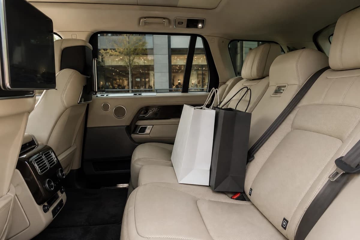 Range Rover rear cabin with shopping bags for family luxury car rental Dubai at Mall of the Emirates
