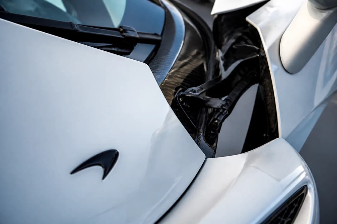 McLaren Speedmark badge and dihedral door hinge on a white Artura for McLaren rental Dubai guide identity