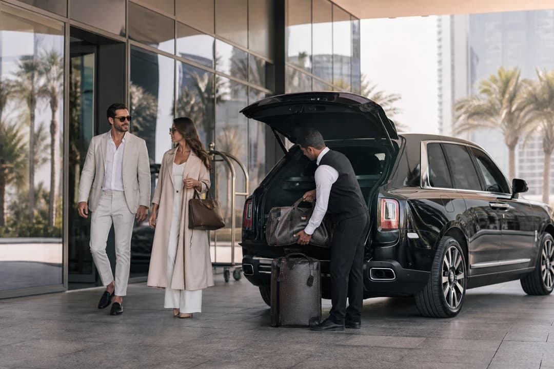 Best cars to rent Dubai day one: black luxury SUV at a hotel porte-cochère with soft travel bags