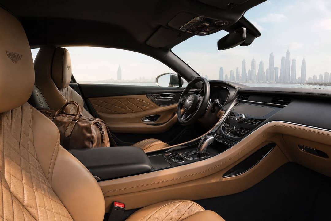 UAE road trip rental cabin: leather grand tourer seats with a soft overnight bag for day-three composure