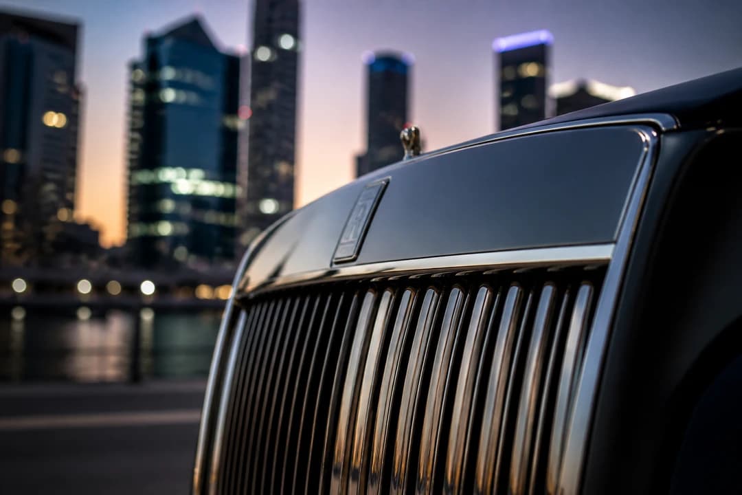 Luxury sedan grille detail with Dubai Marina towers soft behind for 3 day Dubai luxury car itinerary identity