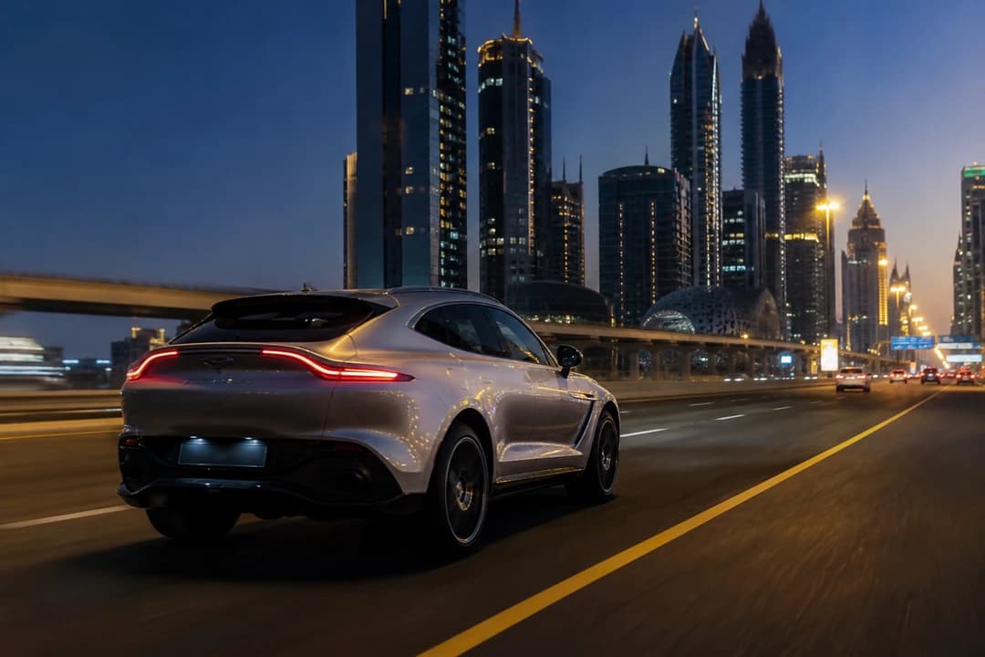 Rent Aston Martin DBX Dubai: silver DBX on Sheikh Zayed Road at blue hour for exotic car rental Dubai highway weeks
