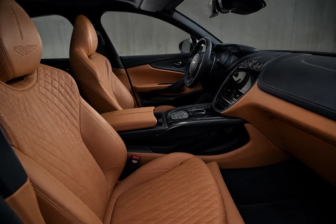 Aston Martin DBX hire Dubai quilted sport seats and driver-focused cockpit for luxury car rental Dubai city weeks
