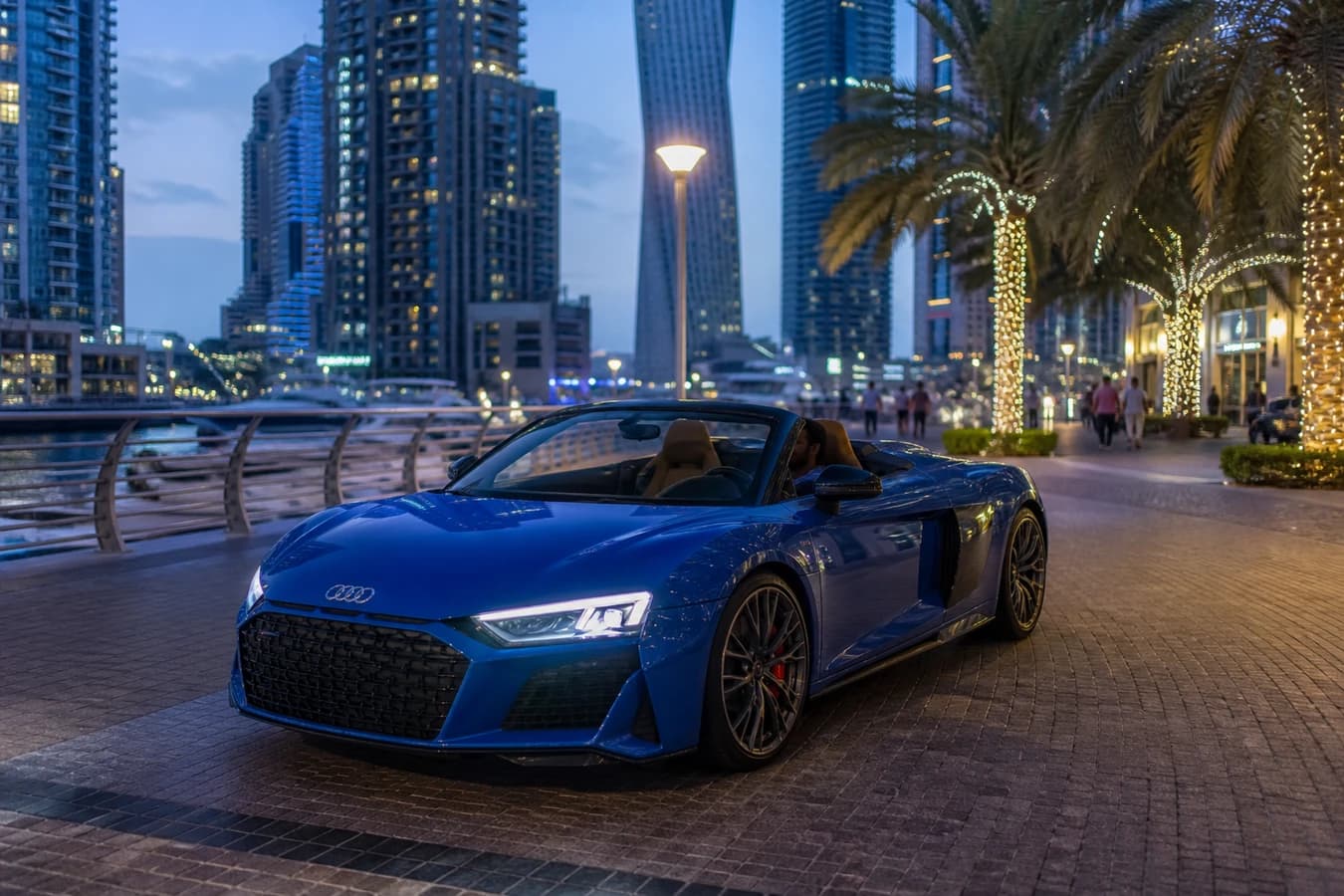 Audi R8 Spyder rental Dubai hero with an open-top R8 on Dubai Marina Walk at blue hour