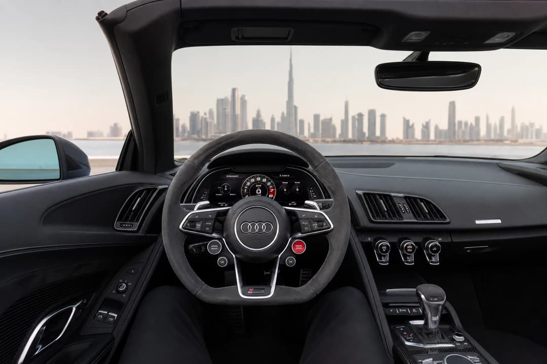 Audi R8 Spyder hire Dubai cockpit with roof open for Marina evening drives