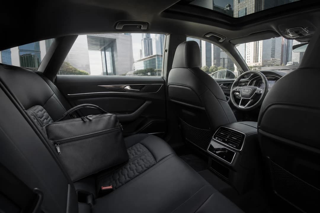 Audi RS7 hire Dubai cabin with a soft laptop bag on the rear seat for DIFC executive days