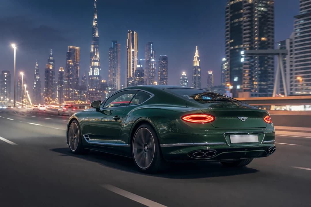 Bentley Continental GT Speed on Sheikh Zayed Road at blue hour for exotic car rental Dubai long-day touring