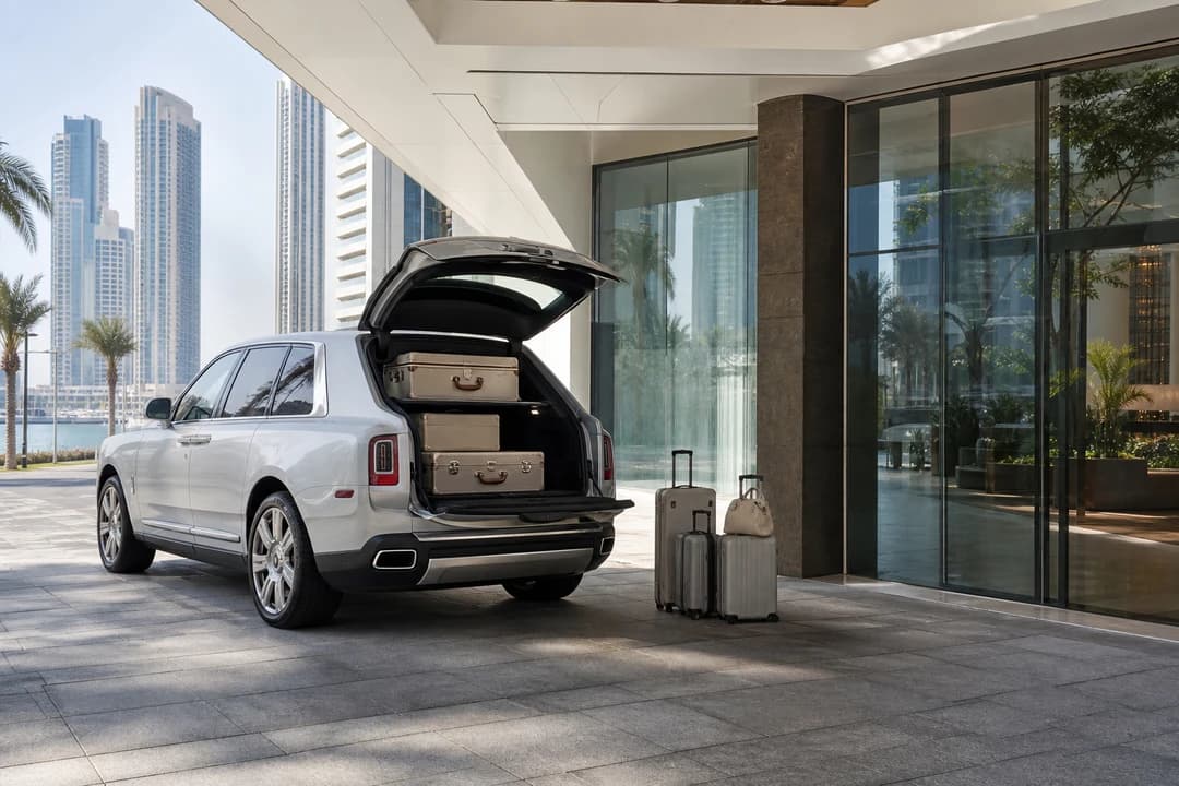 Luxury SUV Creek Harbour tower arrival with Cullinan luggage at a residential porte-cochere