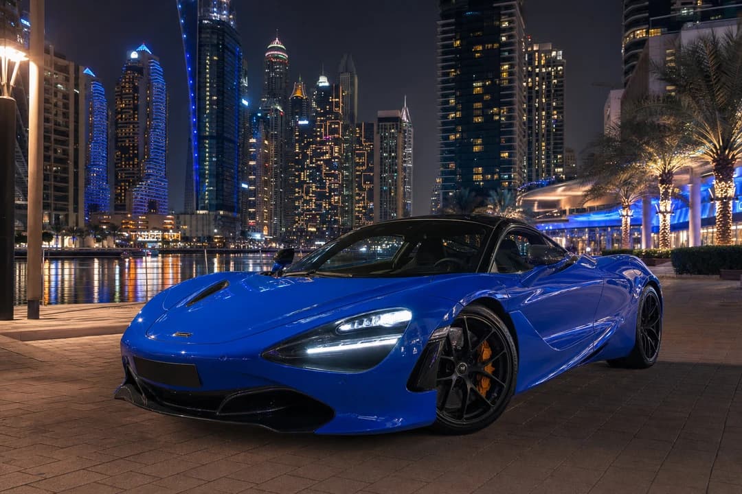 McLaren 720S on Dubai Marina Walk at night for evening supercar rental plans