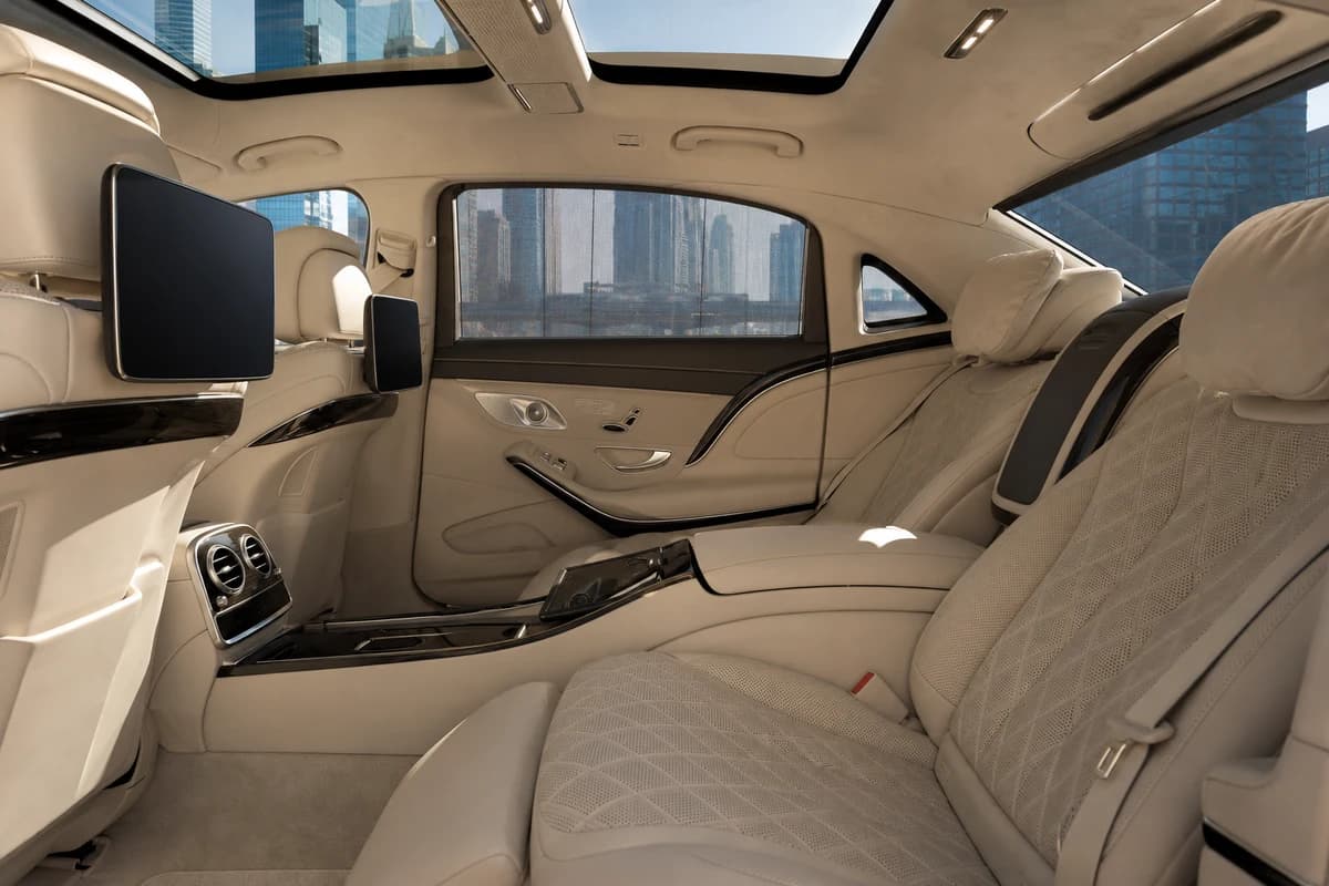 Maybach rear cabin for DIFC client meetings with finance-district towers through the windows