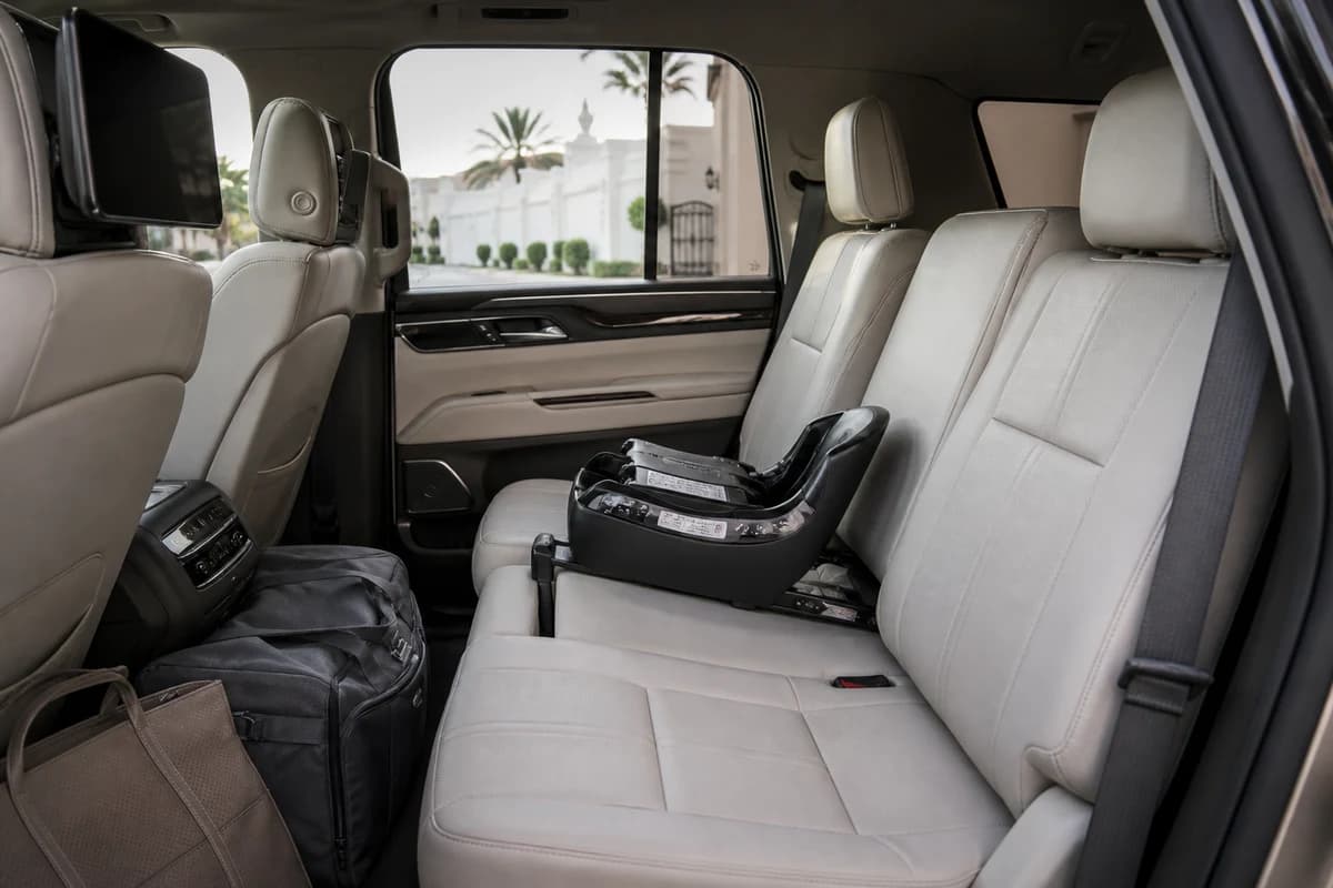 Luxury SUV rear cabin with child seat base and soft bags for Arabian Ranches family villa weeks