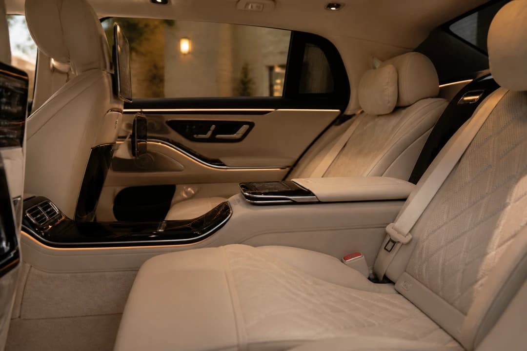Best cars to rent Dubai hotel stay: calm executive sedan rear cabin with soft ambient light