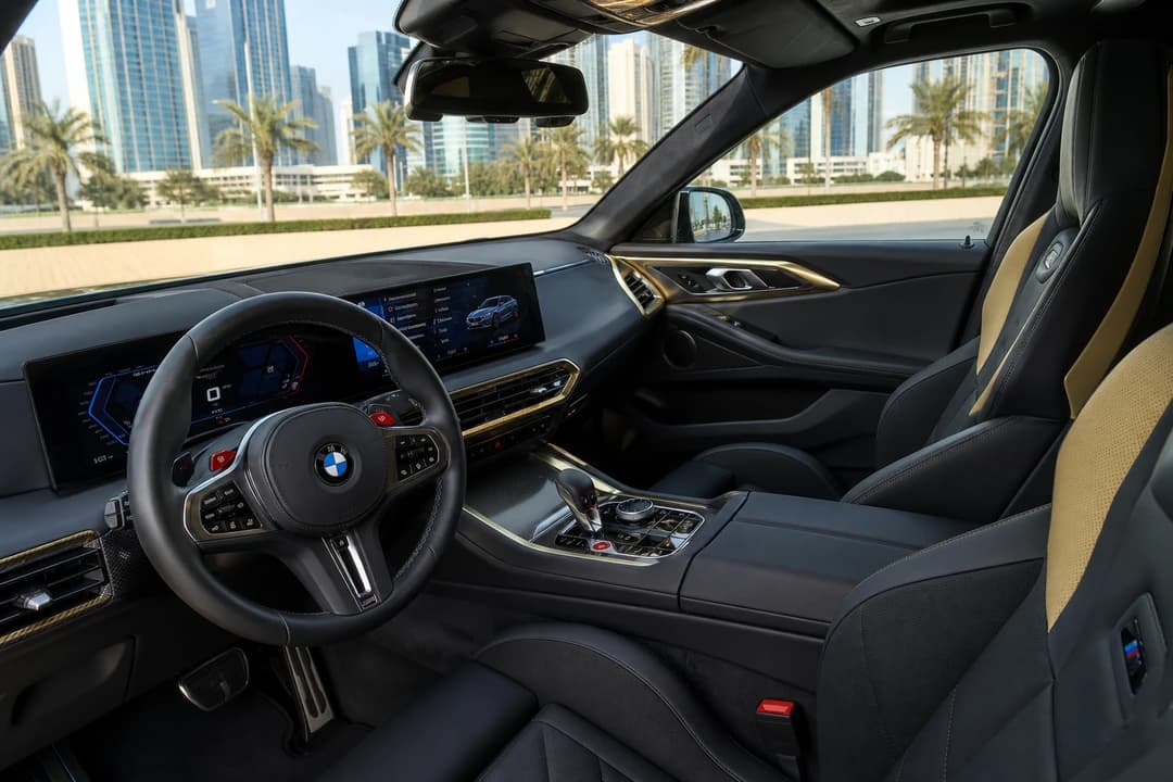 BMW XM hire Dubai cabin with curved displays and M hybrid seats for executive SUV weeks