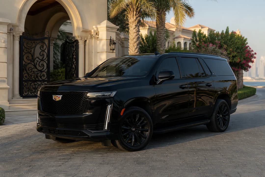 Cadillac Escalade at a Palm villa gate for luxury car comparison Dubai full-size SUV scale