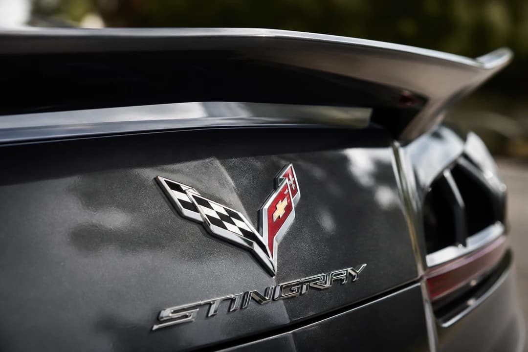 Chevrolet Corvette Stingray crossed-flags badge and rear deck detail for Chevrolet Corvette rental Dubai identity