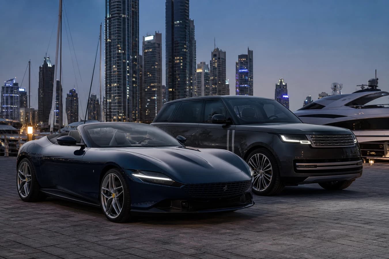 Convertible vs luxury SUV rental Dubai hero with Ferrari Roma Spider and Range Rover at Marina promenade blue hour