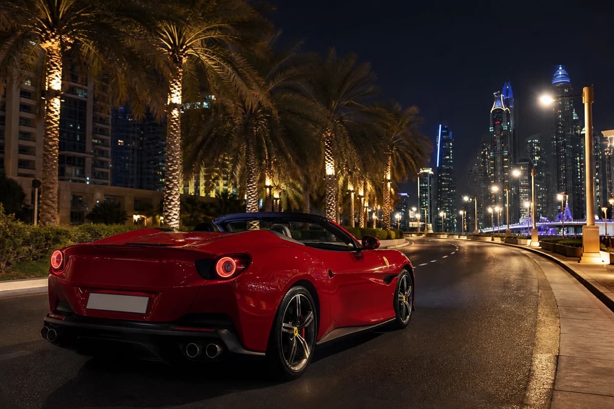 McLaren spider convertible on JBR coastal road after sunset for supercar rental Dubai open-top evenings