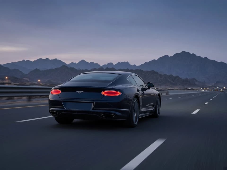 Grand tourer coupe on a UAE highway at blue hour for UAE road trip rental from Dubai