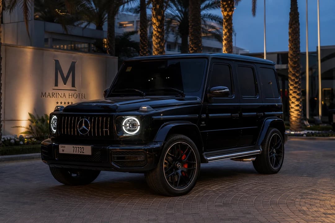 Mercedes-Benz G63 at a Dubai Marina hotel entrance at blue hour for best luxury car Dubai presence