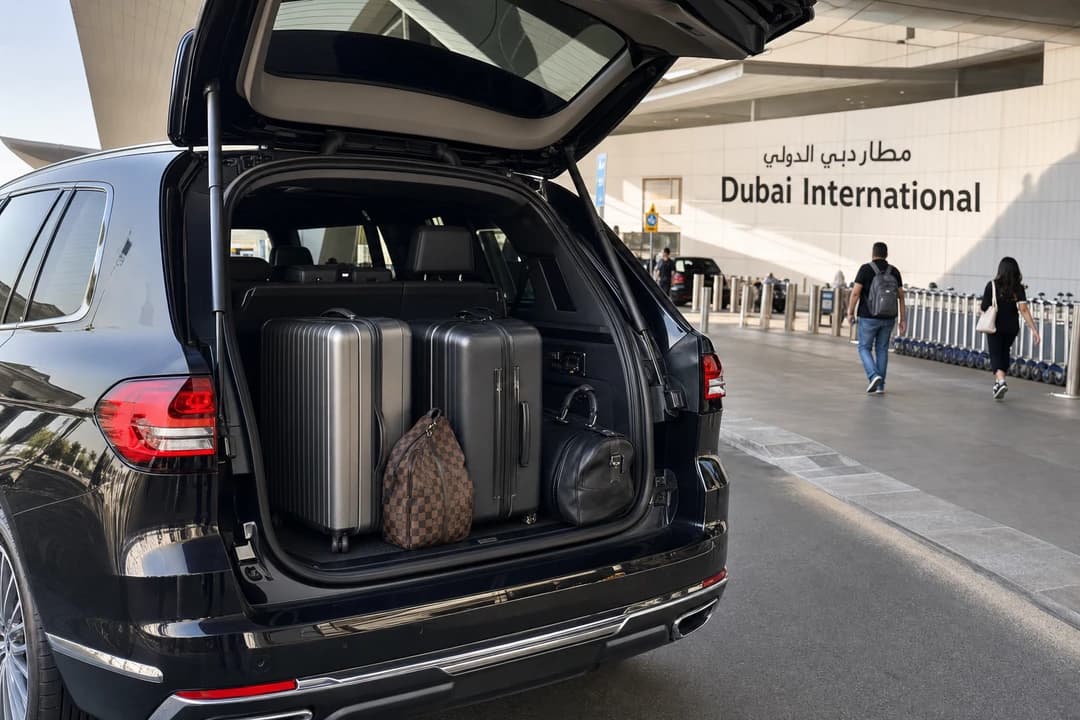 Luxury SUV luggage load at DXB for airport rental car documents Dubai planning