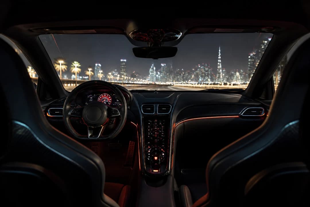 Supercar cabin ambient light during luxury car rental Dubai summer night drive