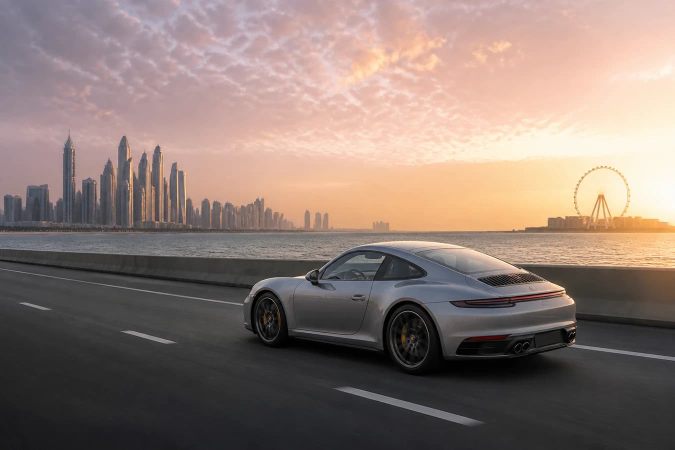 Dubai sunrise drive luxury car: silver sports coupe on a quiet coastal highway at soft pink dawn