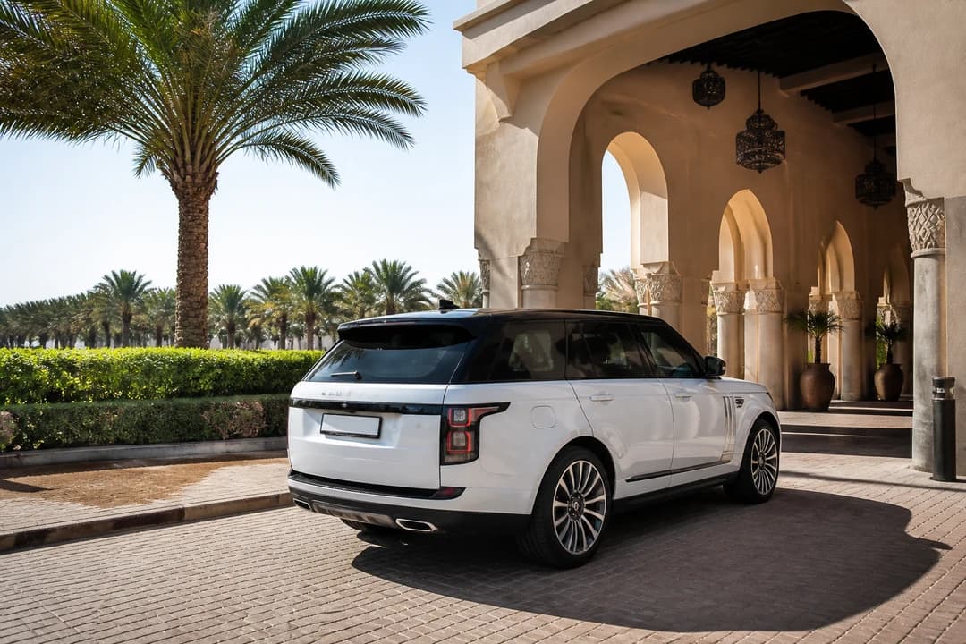 Best cars to rent Dubai for Al Ain: luxury SUV at an oasis hotel porte-cochère after a UAE road trip rental day