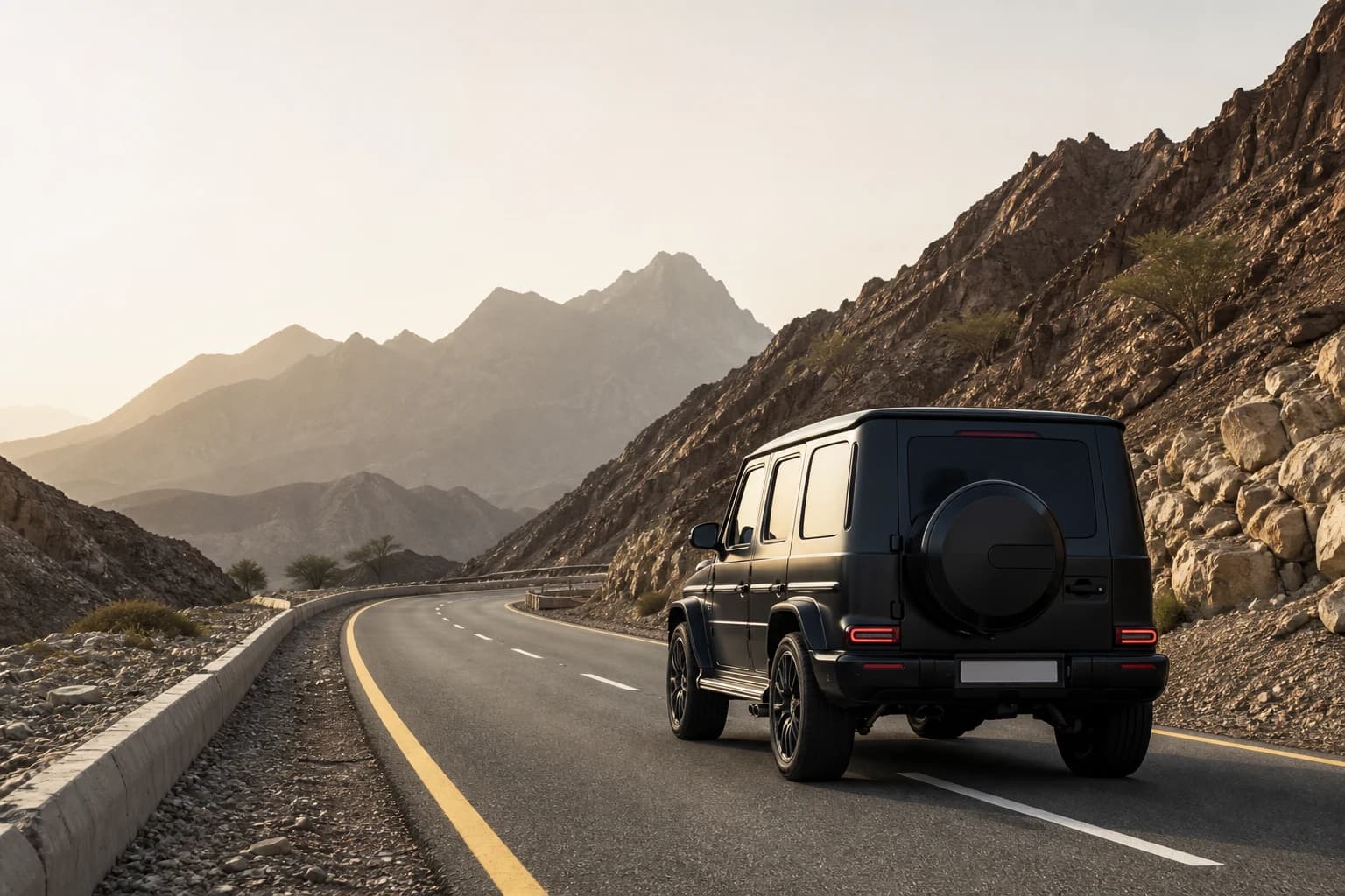 Dubai to Hatta luxury car road trip: luxury SUV on the mountain highway toward Hatta at morning