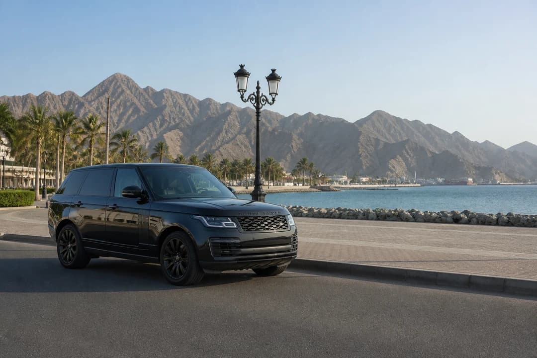 Best cars to rent Dubai for Khor Fakkan: luxury SUV at a quiet east-coast corniche with mountains and sea