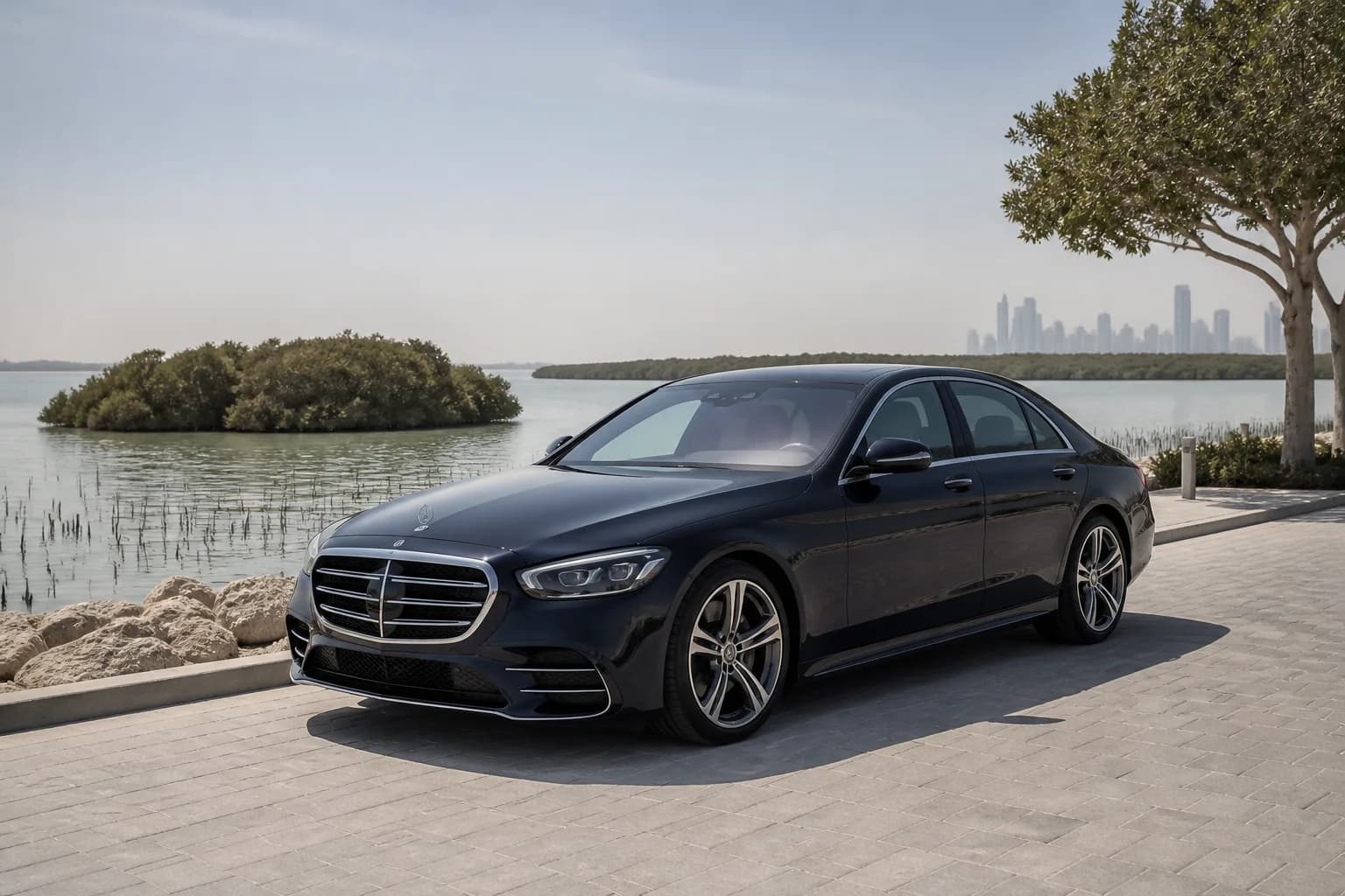 Best cars to rent Dubai for Umm Al Quwain: luxury sedan near a calm northern mangrove coast promenade