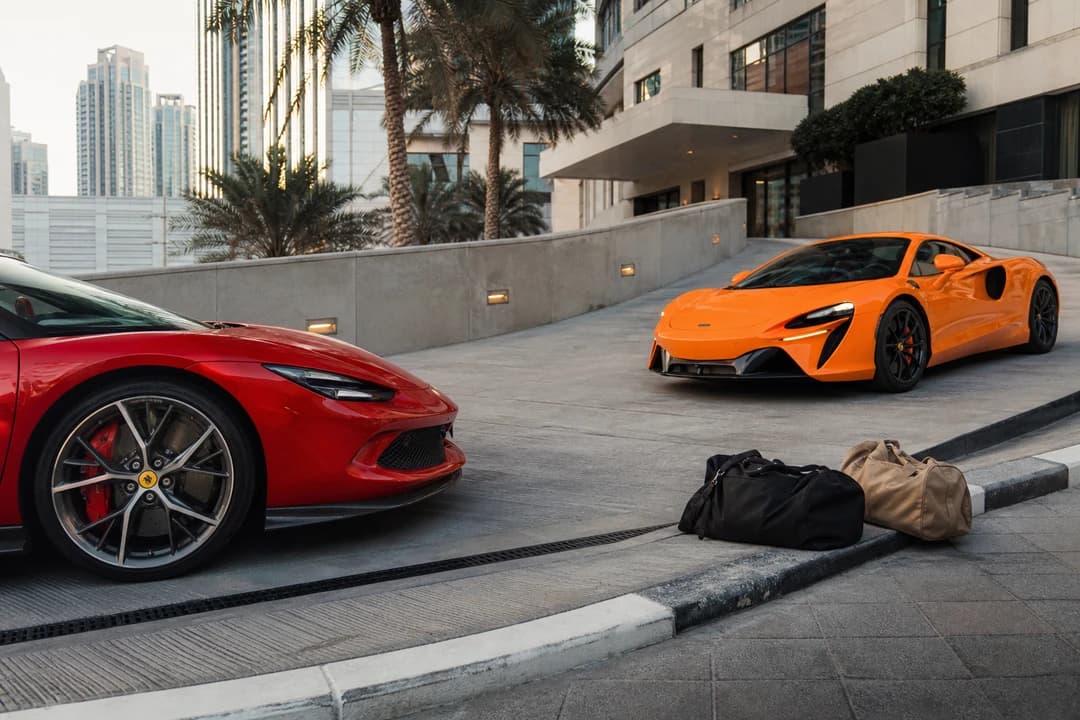 Ferrari 296 GTB and McLaren Artura at a steep d3 ramp for luxury car hire Dubai nose clearance and soft bags