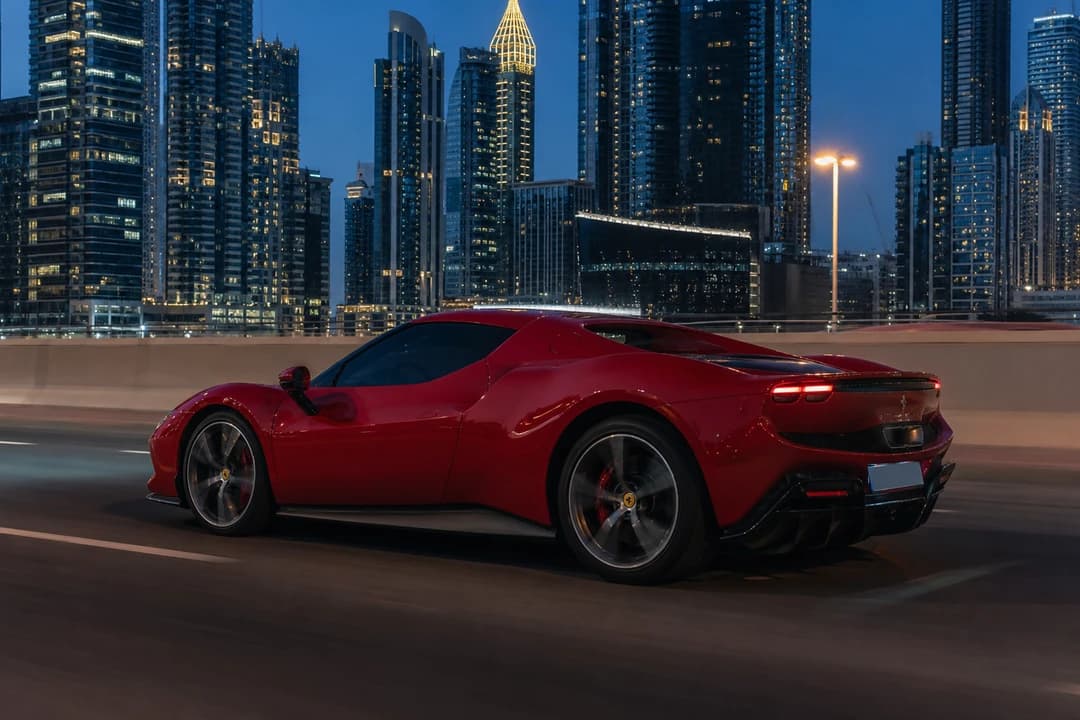 Ferrari 296 GTB coupe on Sheikh Zayed Road at blue hour for luxury car hire Dubai closed-cabin evenings