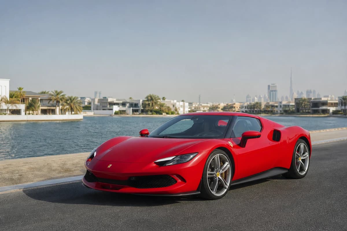Rent Ferrari Dubai: 296 GTB on a quiet creek-side road in morning light