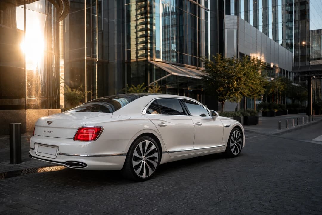 Bentley Flying Spur at DIFC Gate District in golden hour for luxury car comparison Dubai executive hops